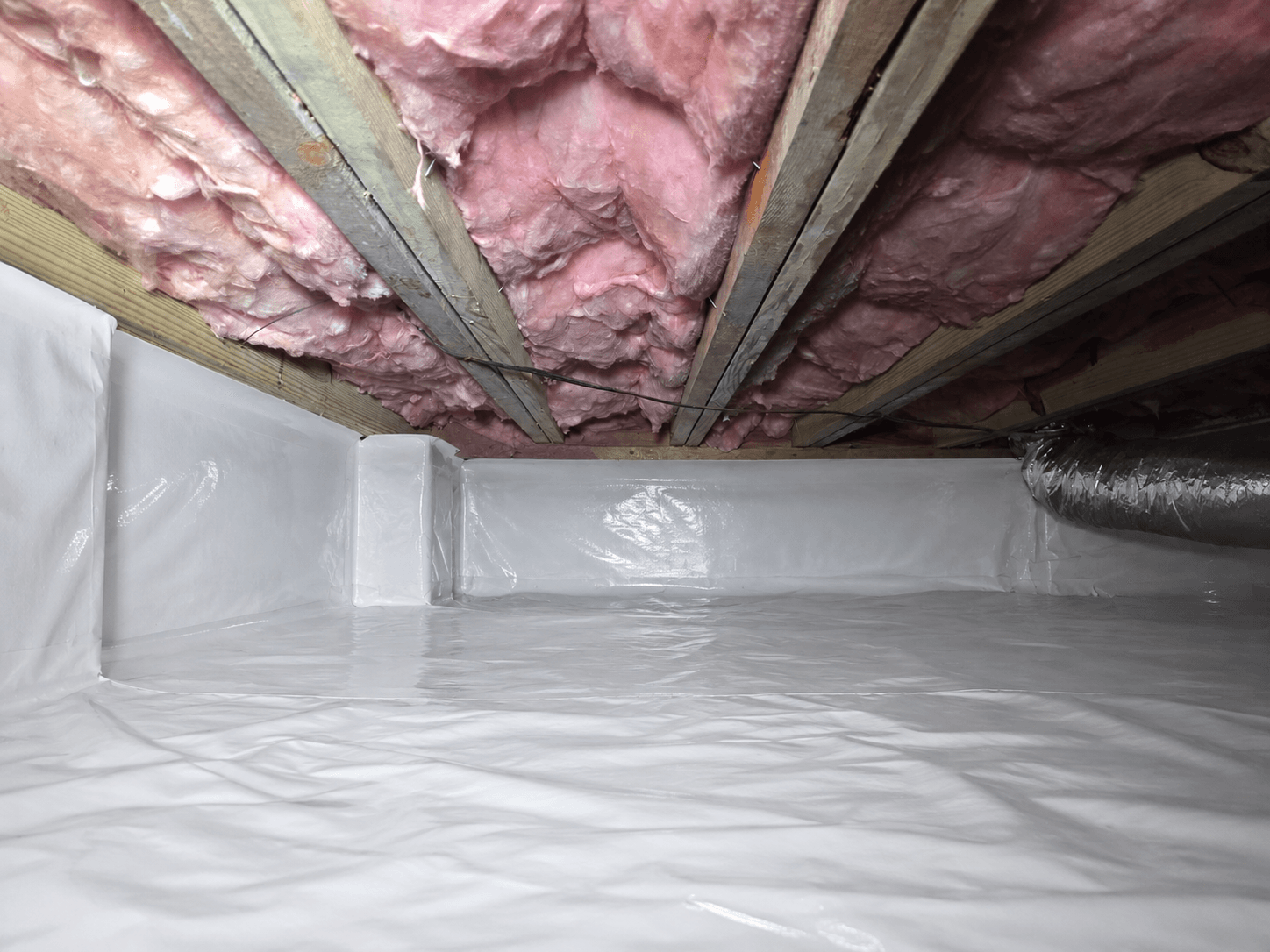 Charlotte crawl space after Carolux heavy-duty vapor barrier installation
